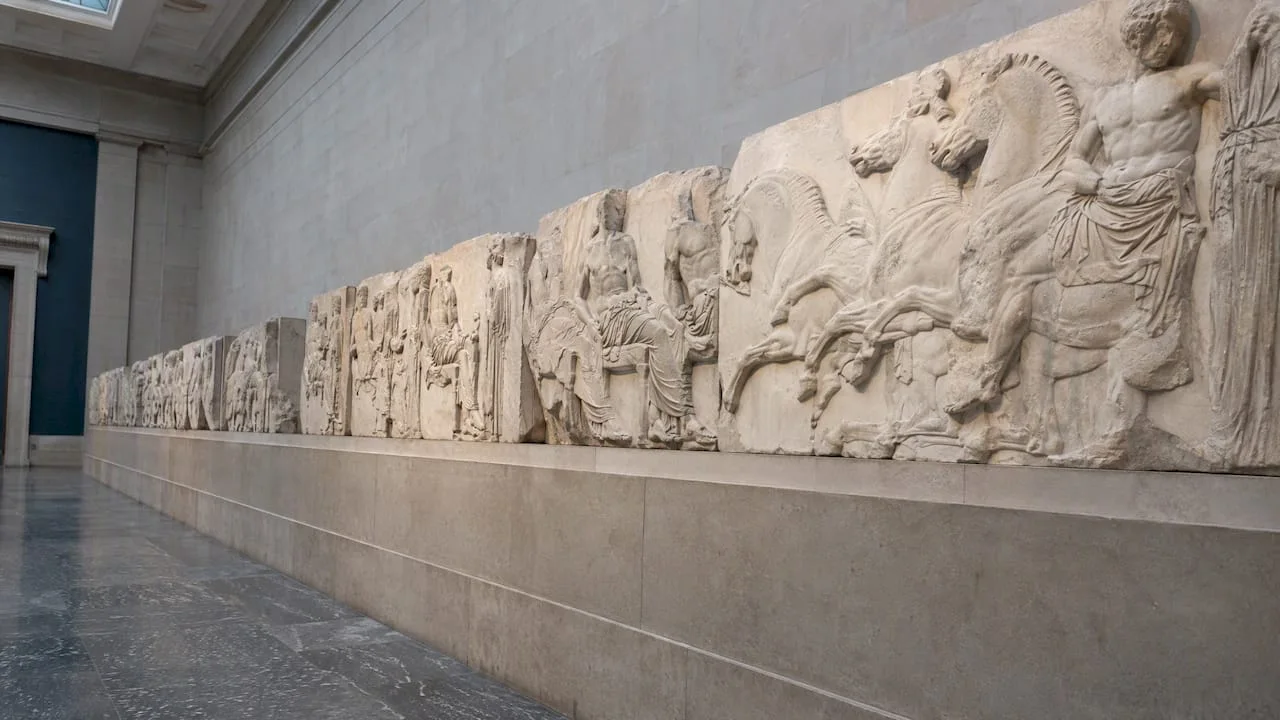 Marble Parthenon sculptures along a gallery wall