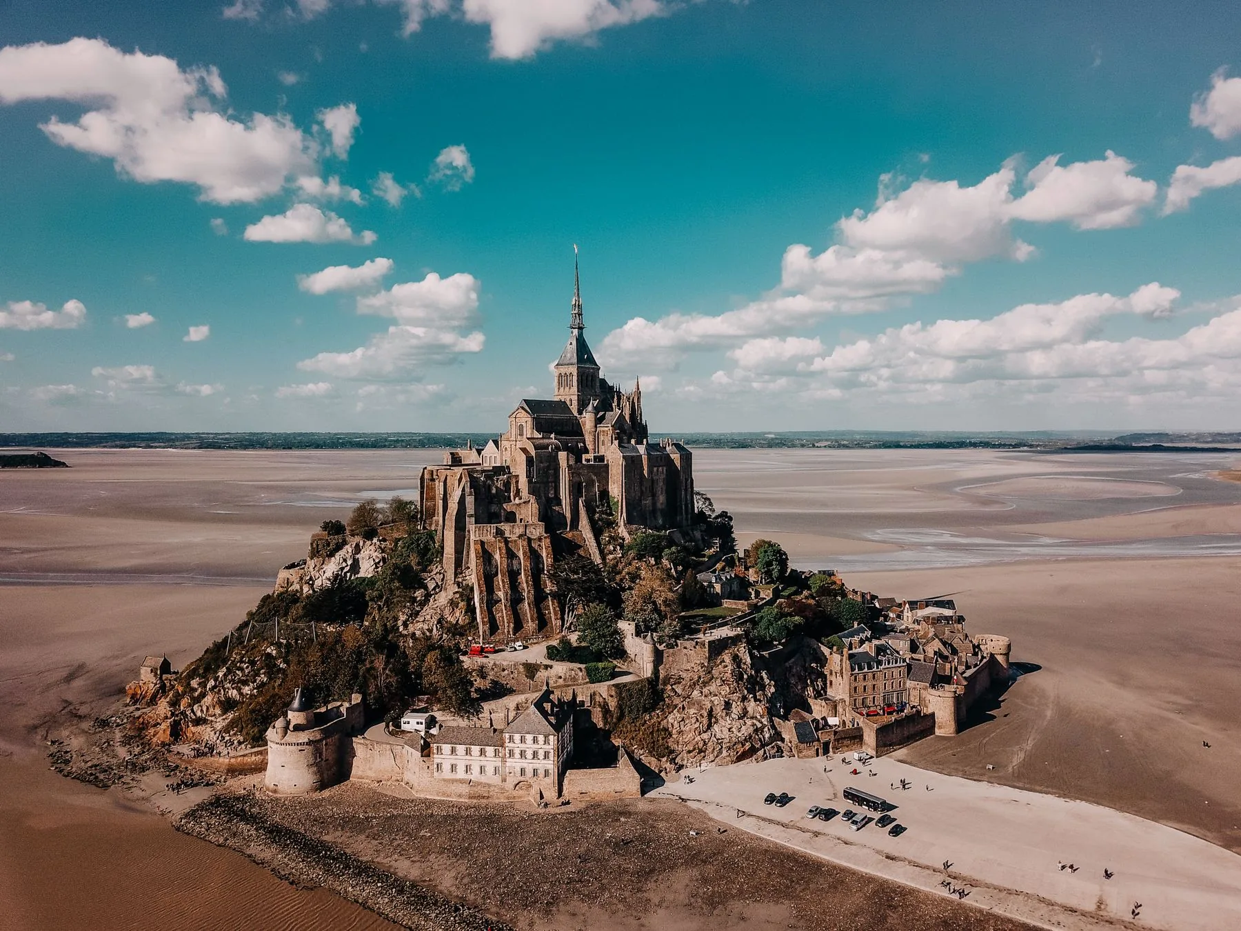 Mont-Saint-Michel Abbey rising above the village and tidal bay in Normandy